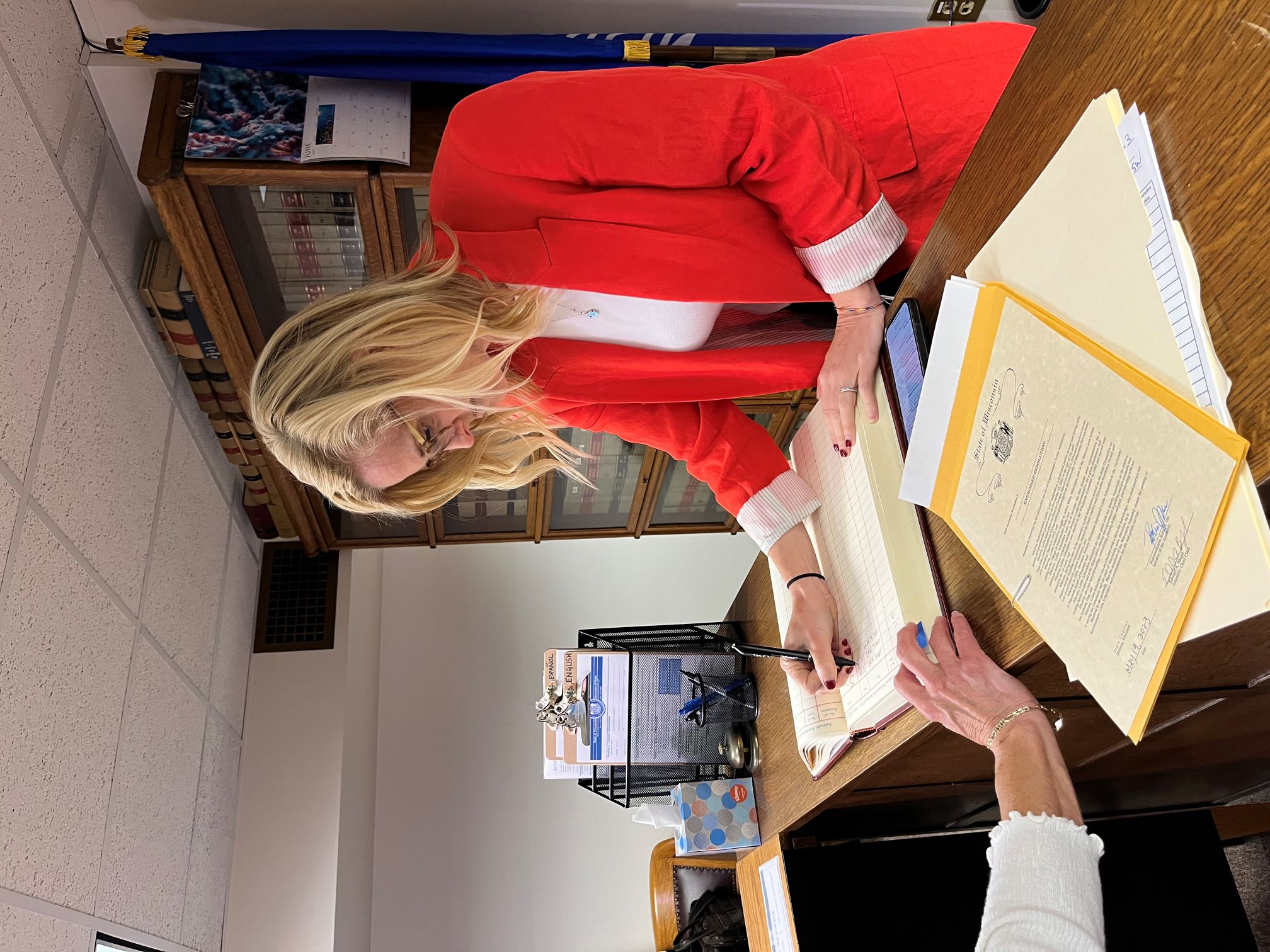 Sec. Godlewski signing the book to confirm filing of legislature documents